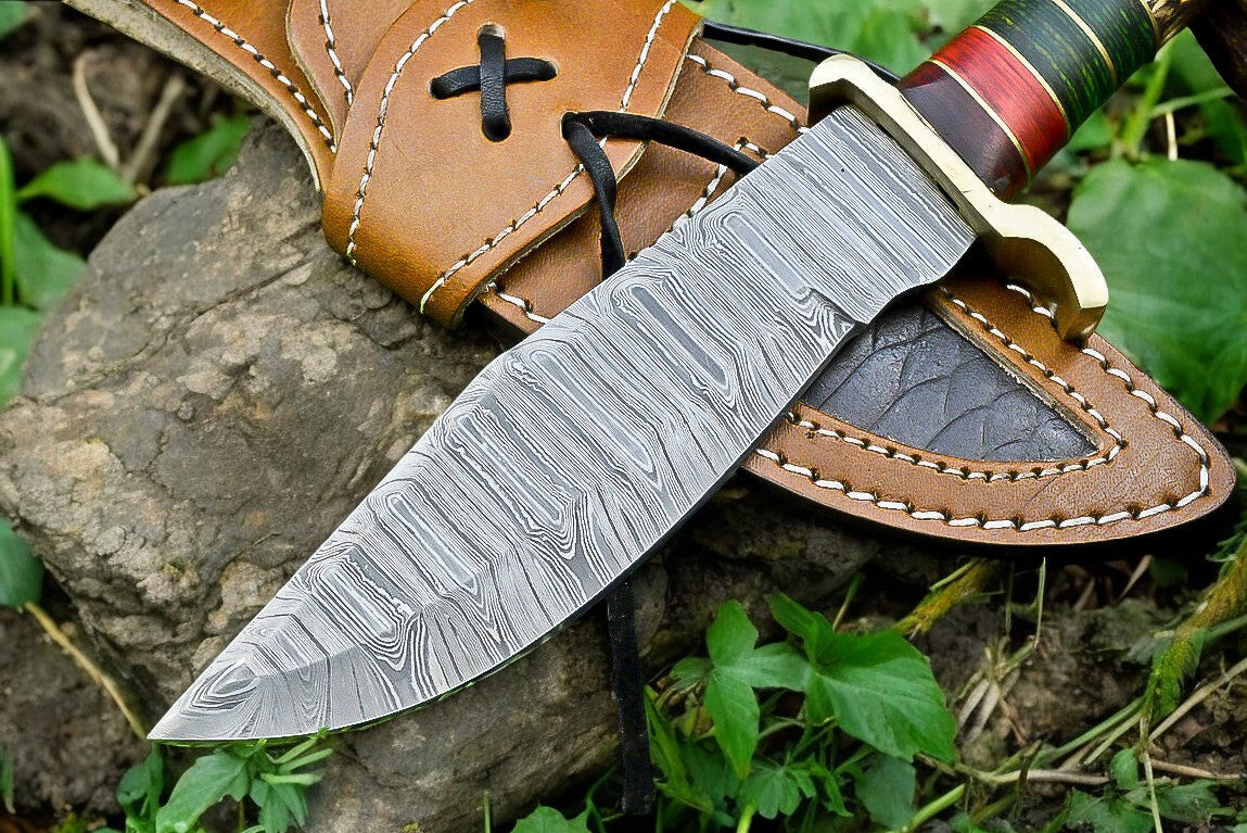 The hunting knife resting on a rustic surface, emphasizing its craftsmanship.