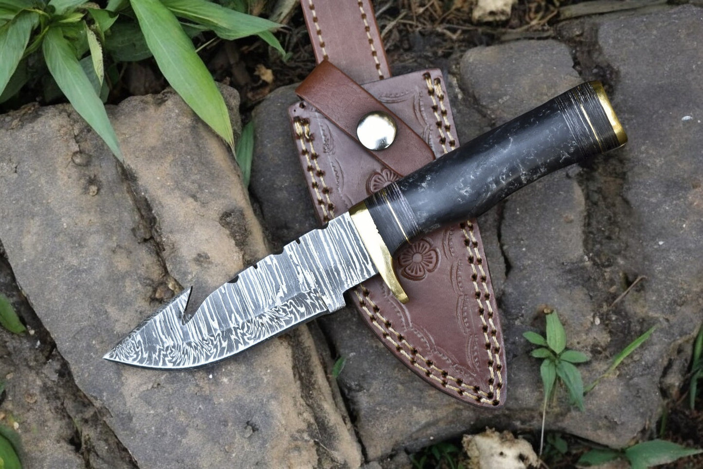 Detailed shot of the custom hunting knife’s blade and handle, emphasizing craftsmanship.