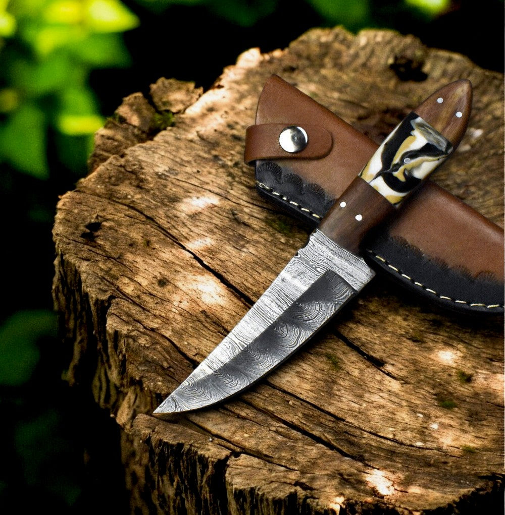 Handmade hunting skinning knife with epoxy resin and rosewood handle.