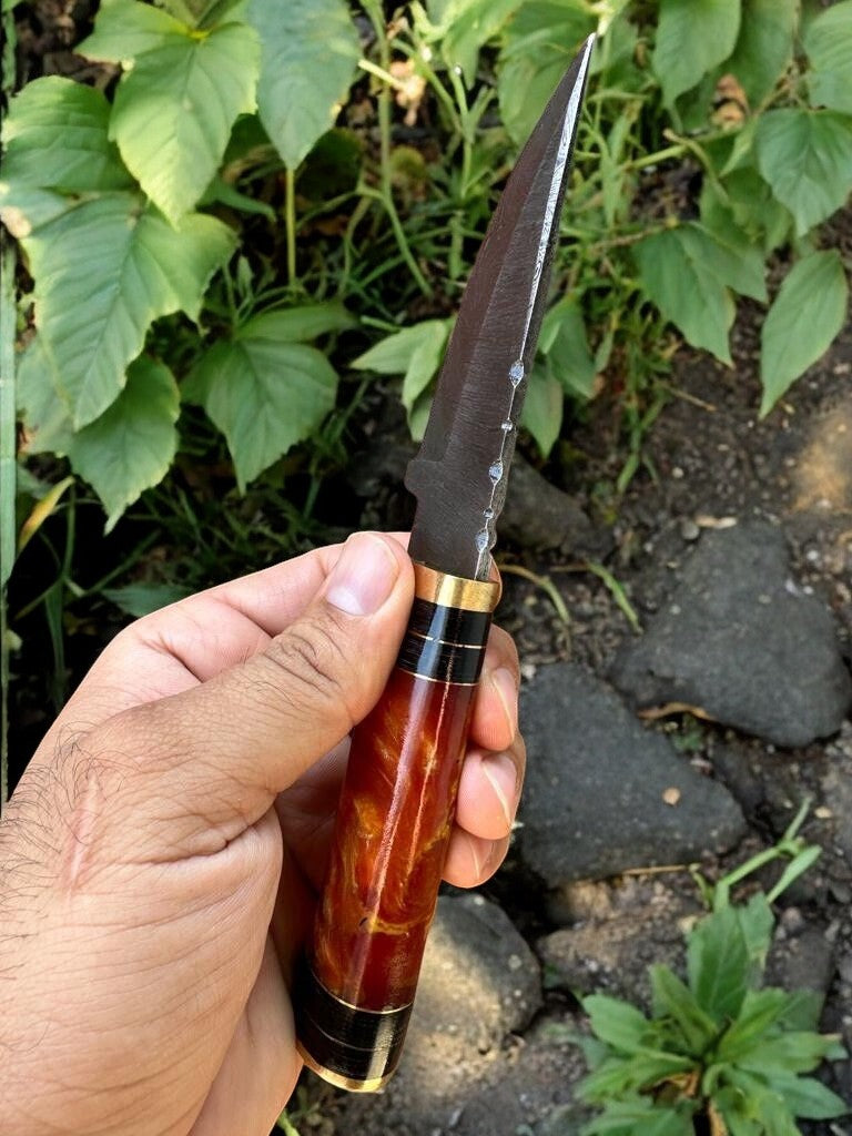 Handmade hunting knife with 3.75-inch Damascus steel blade and epoxy resin handle.