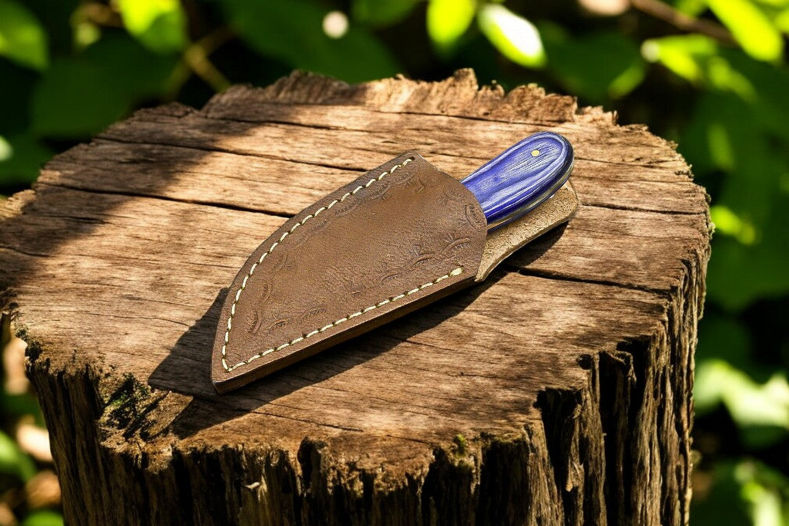 Custom skinning knife displayed with its leather sheath.