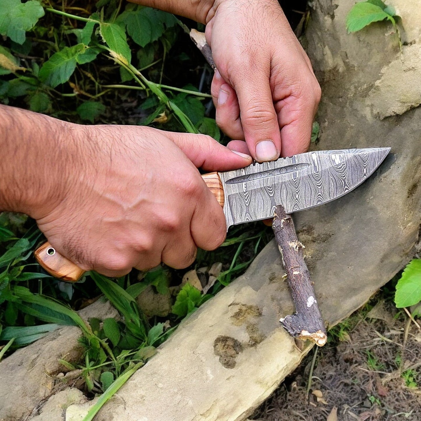 High end hunting knife with 4.5-inch Damascus steel blade and olive wood handle.