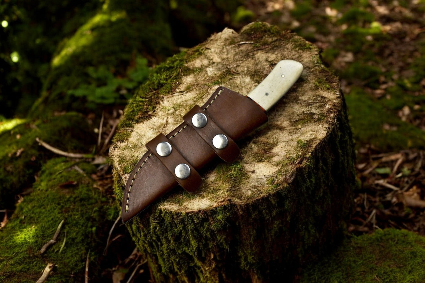 Leather sheath for small skinning knife with Damascus blade.