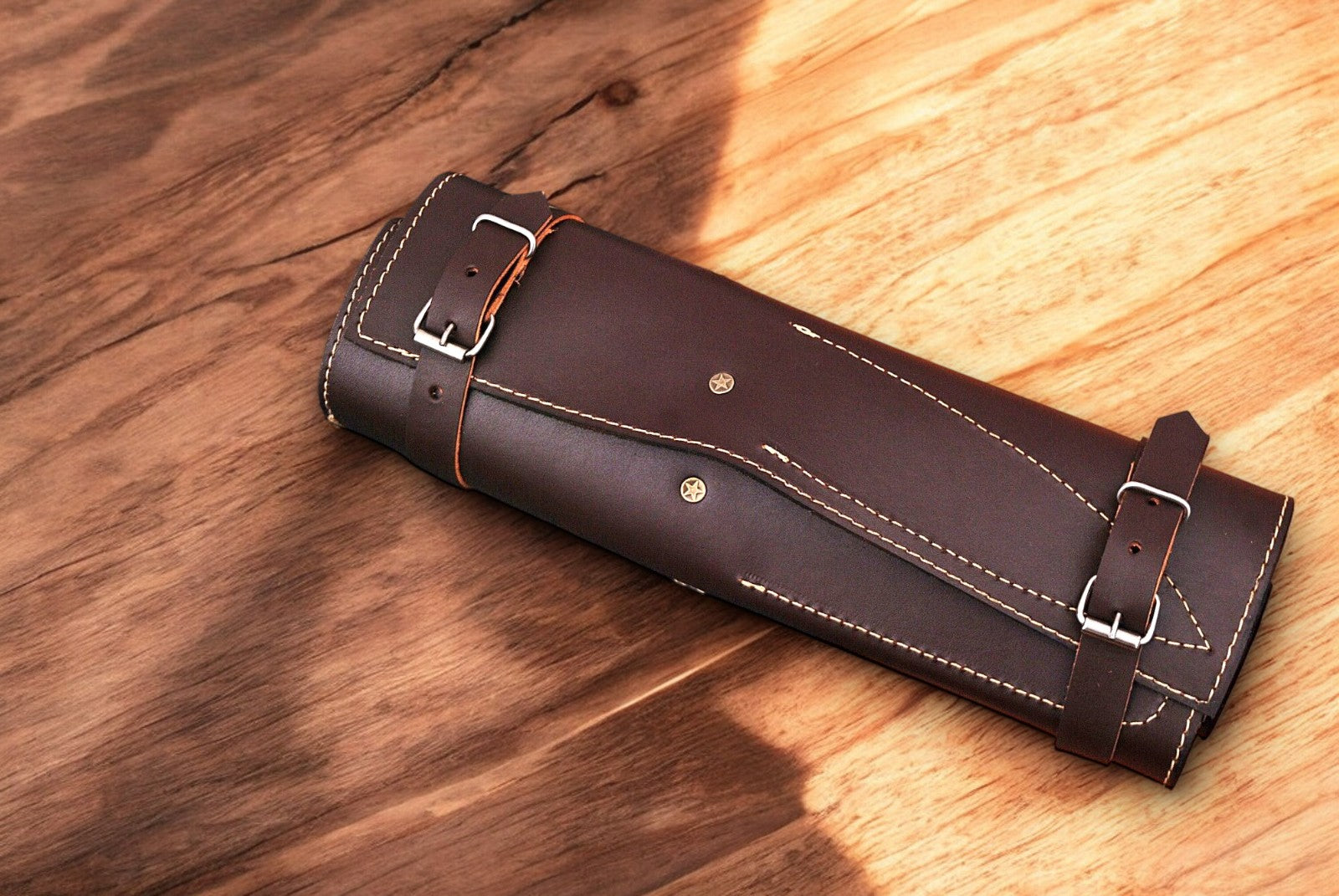 Full set of Damascus knives displayed in a leather roll.