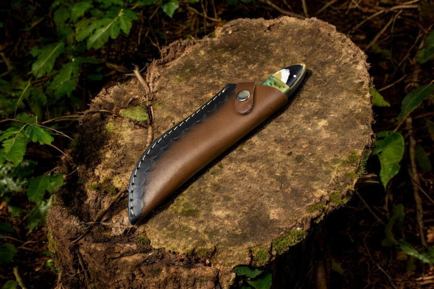 Damascus skinning knife displayed with its premium leather sheath