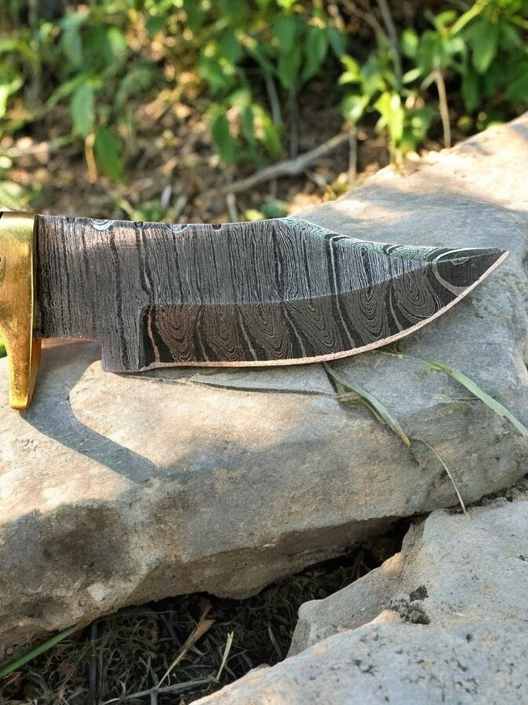 Epoxy resin handle of the hunting knife with brass guard for secure grip.