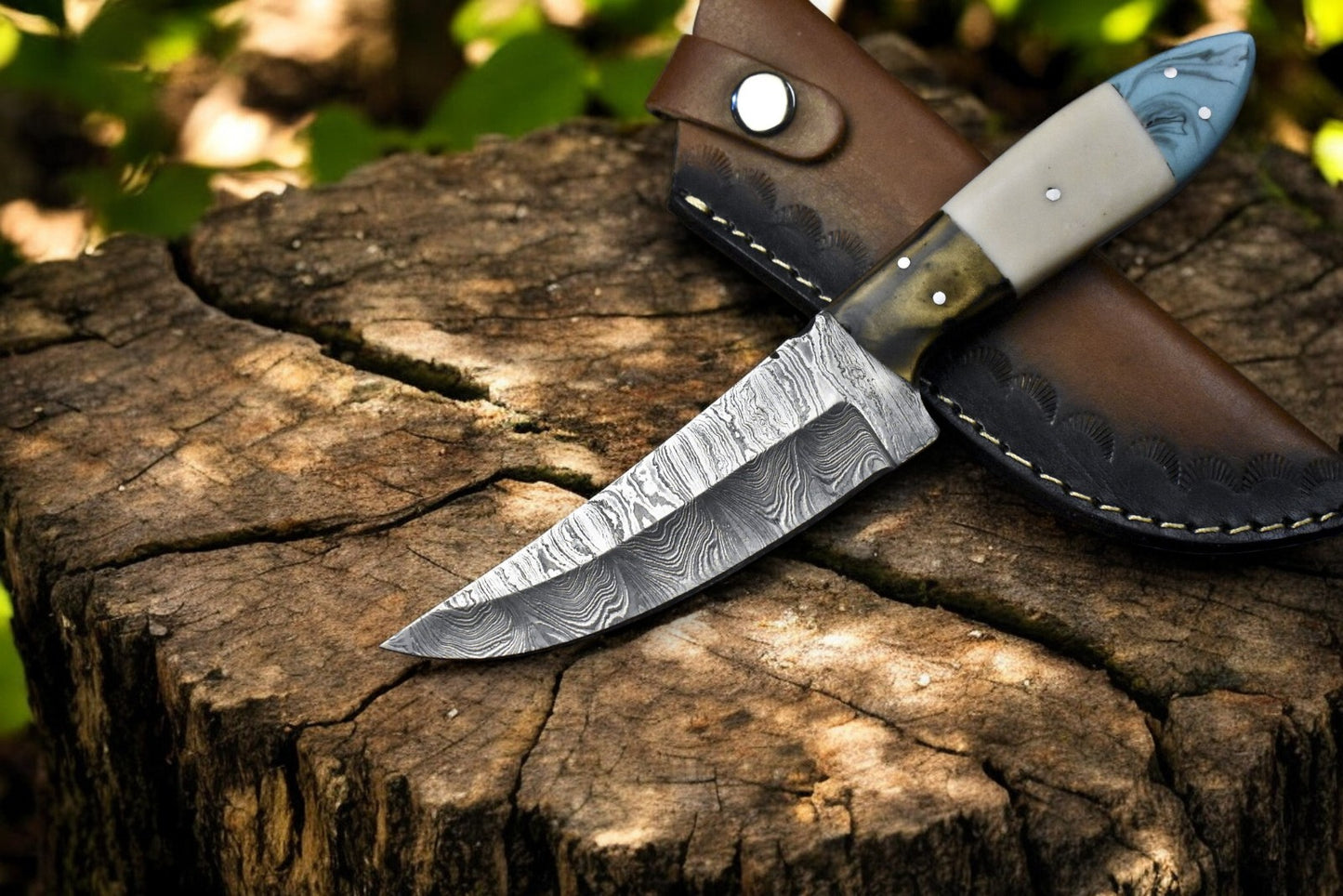 "Custom handmade Damascus steel skinning knife with leather sheath"