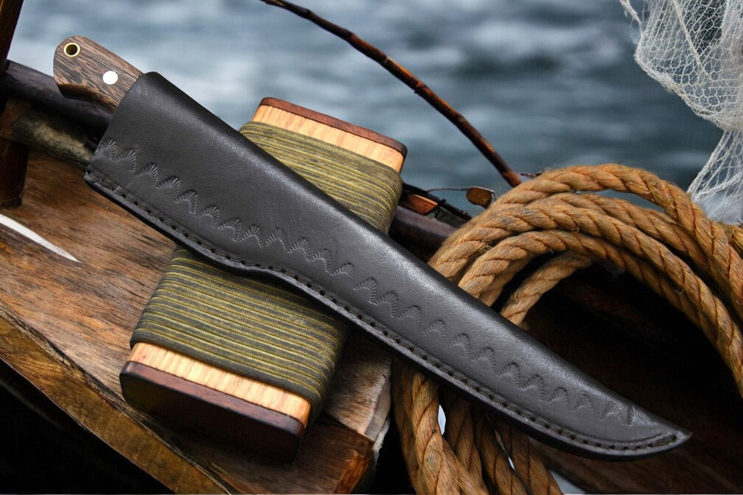 Damascus Steel Fillet Knife displayed with leather sheath