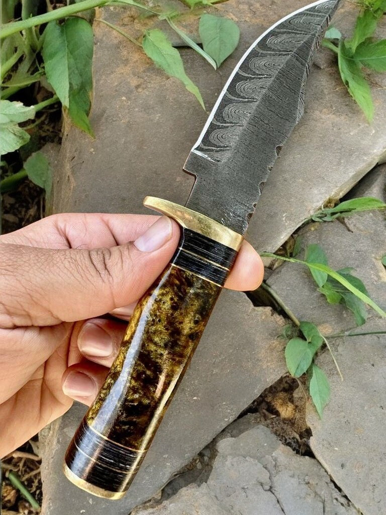 Full view of the hunting knife resting on a wooden surface, highlighting its craftsmanship.