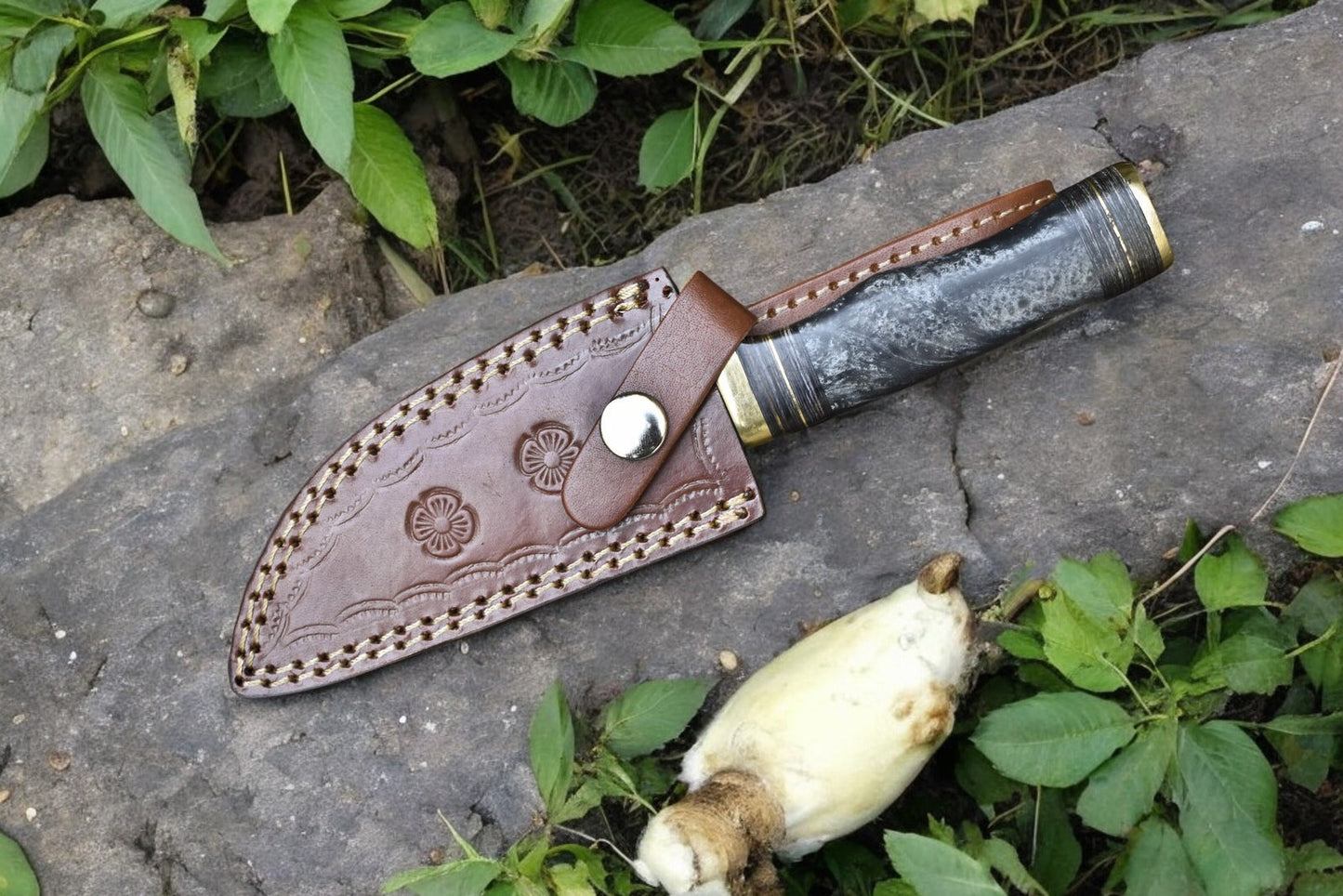 Leather sheath included with the custom hunting knife, displayed alongside the knife.