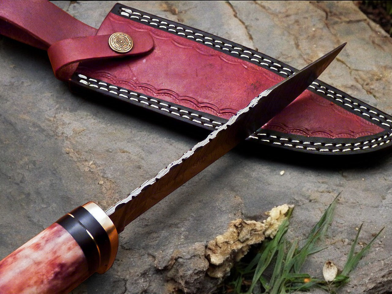 Aerial view of the Damascus steel knife with color bone handle, emphasizing craftsmanship.