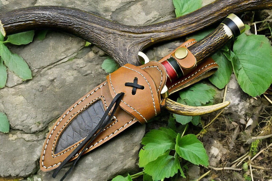 Detail of the antler horn handle and brass guard on the Damascus steel hunting knife.