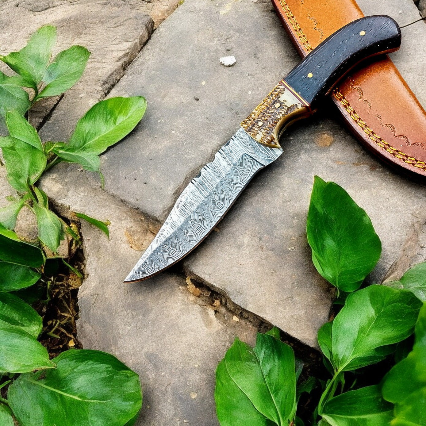Handmade hunting knife with Damascus steel blade and leather sheath
