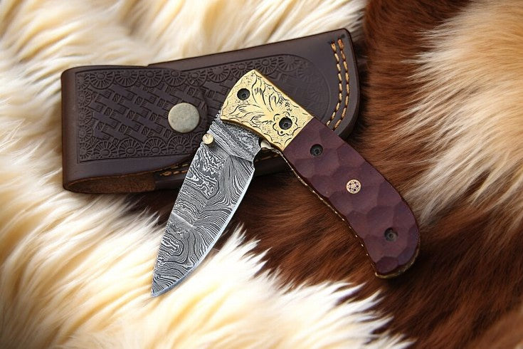 Damascus pocket knife with leather case and liner lock mechanism