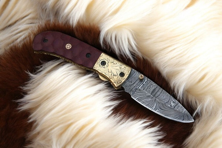  Micarta handle with engraved brass bolster on Damascus pocket knife