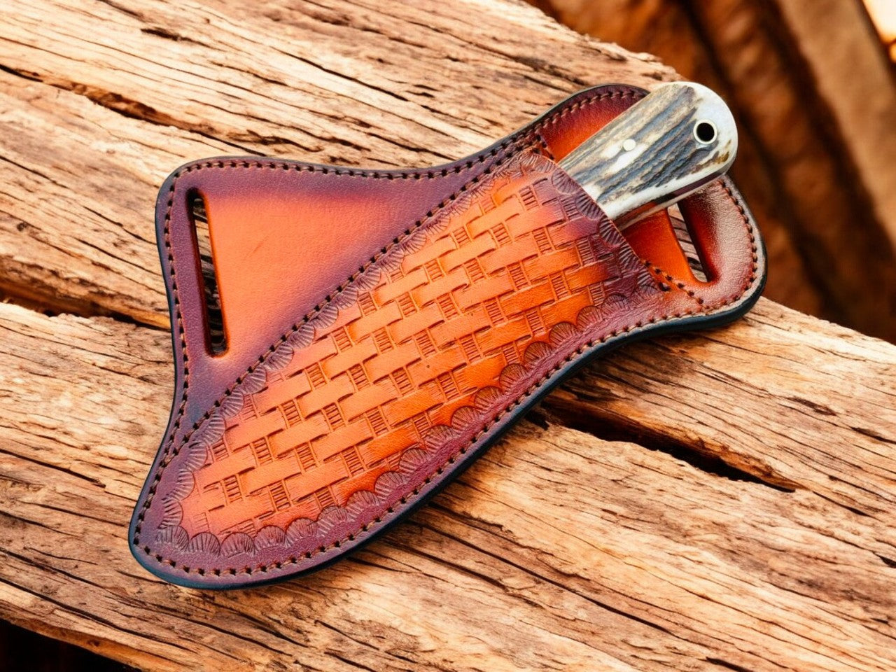 Brown leather knife sheath with woven pattern on a wooden surface