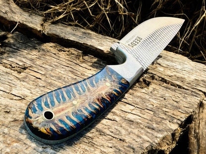 Knife with a decorative handle on a wooden surface