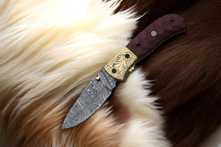  Open Damascus pocket knife showing blade and micarta handle