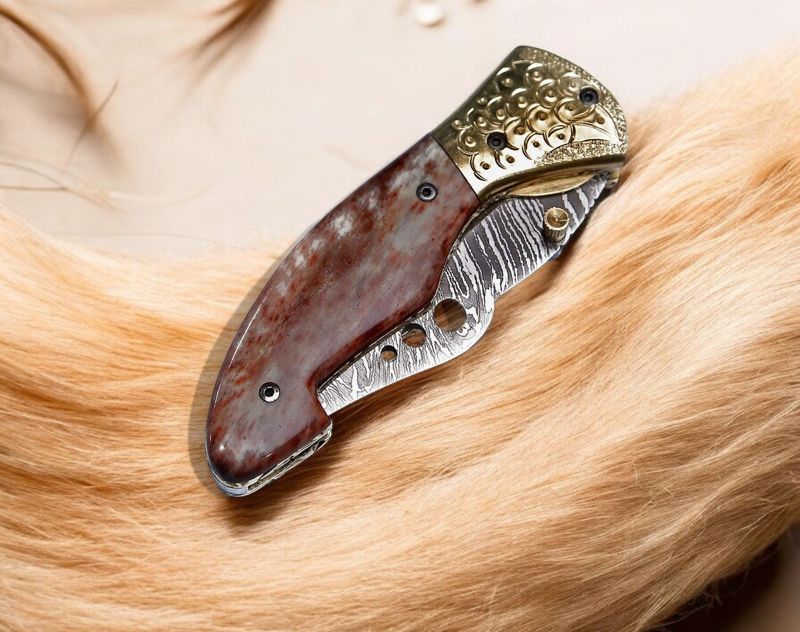 Close-up of the Damascus steel blade on hand engraved pocket knife