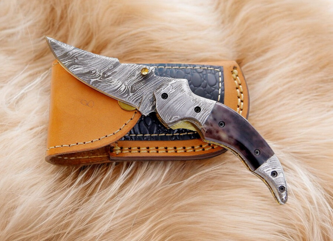 Damascus pocket knife with a 3-inch blade and colored bone handle