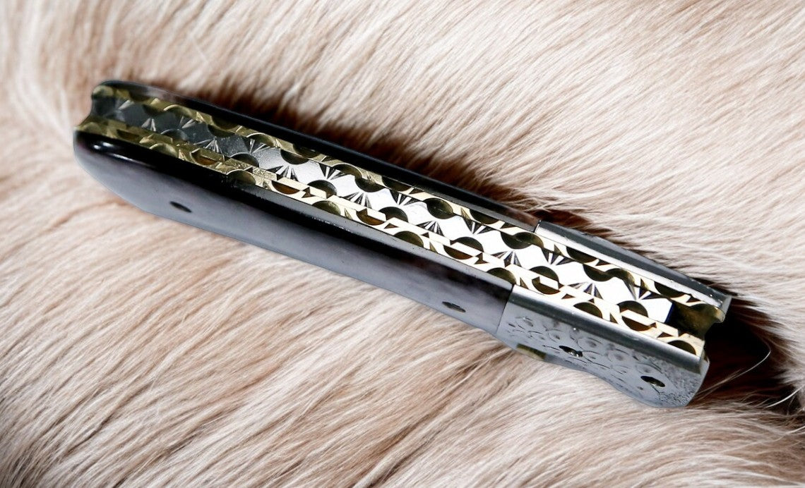  Close-up of the gut hook on Damascus steel pocket knife