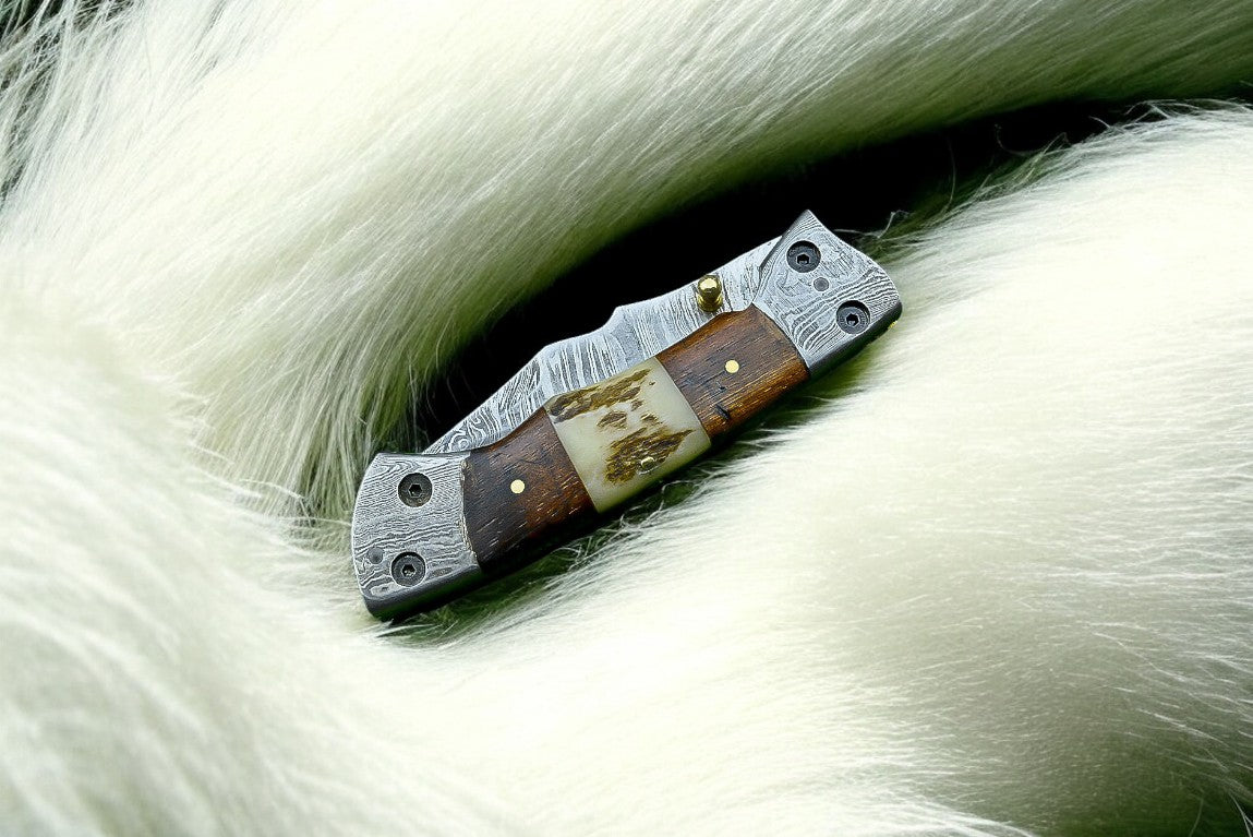 "3-inch Damascus steel blade on a pocket knife."
