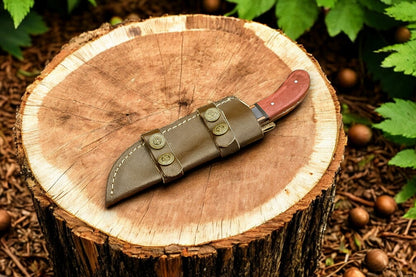 Leather sheath detail of the high-end hunting knife with elegant stitching.