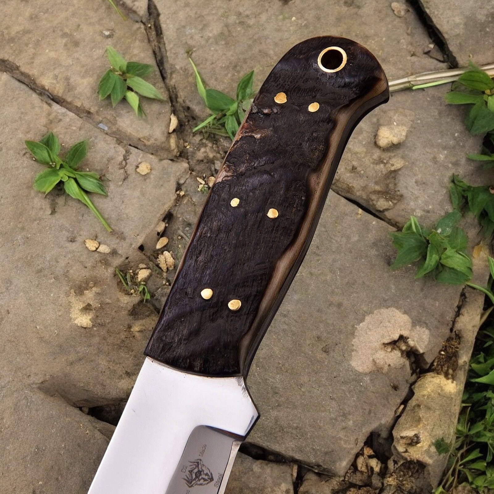 Sheep horn handle of the hunt down knife, offering an ergonomic grip.
