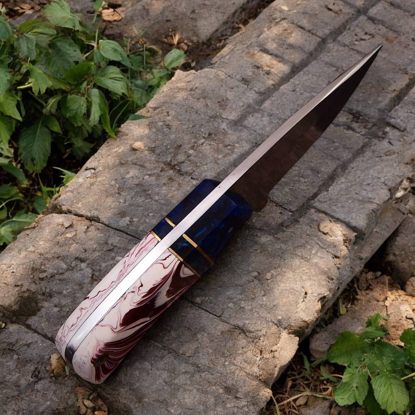 Close-up of high carbon steel blade on hunting knife, showcasing the sharp edge.
