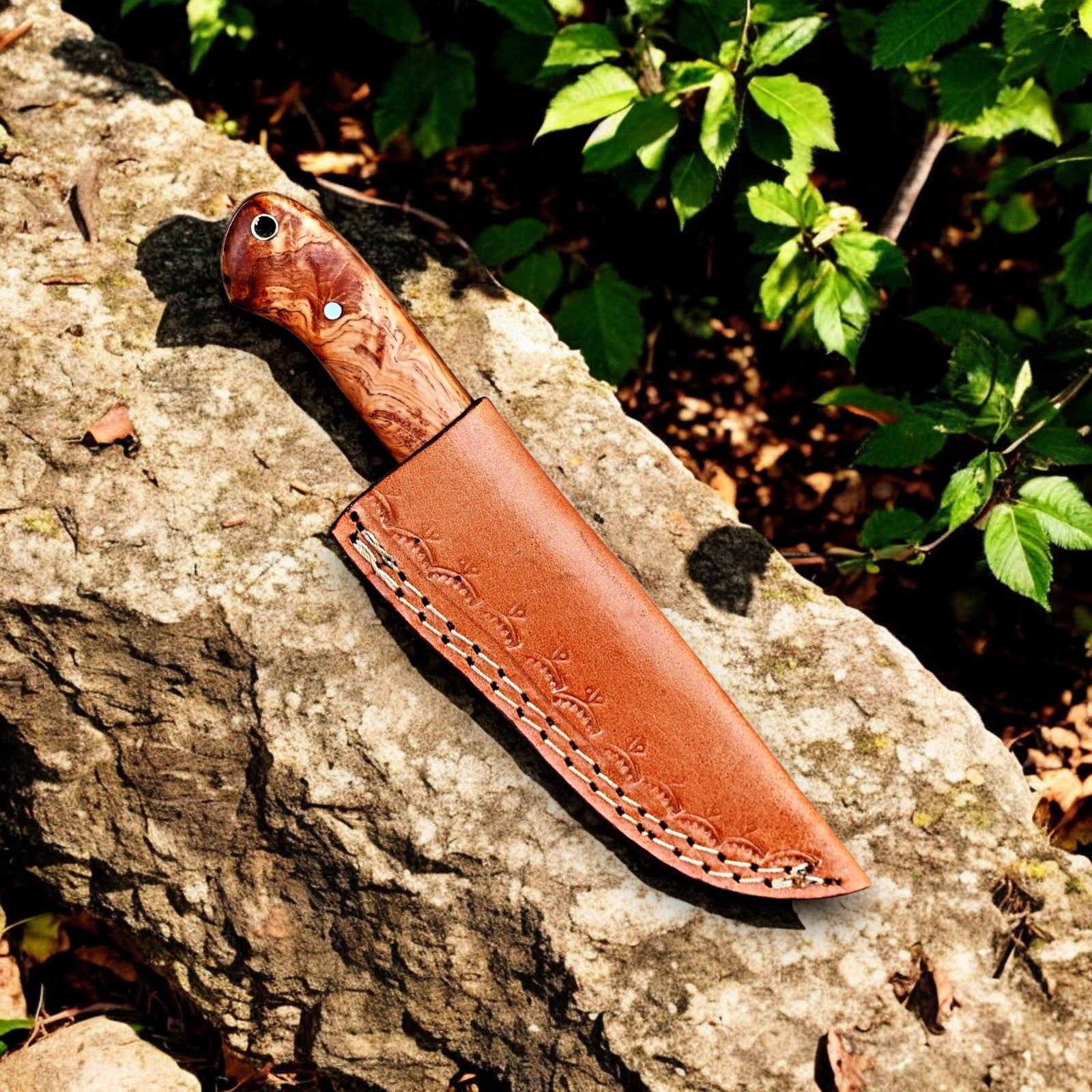 Full set of the custom skinning knife with leather sheath on display.