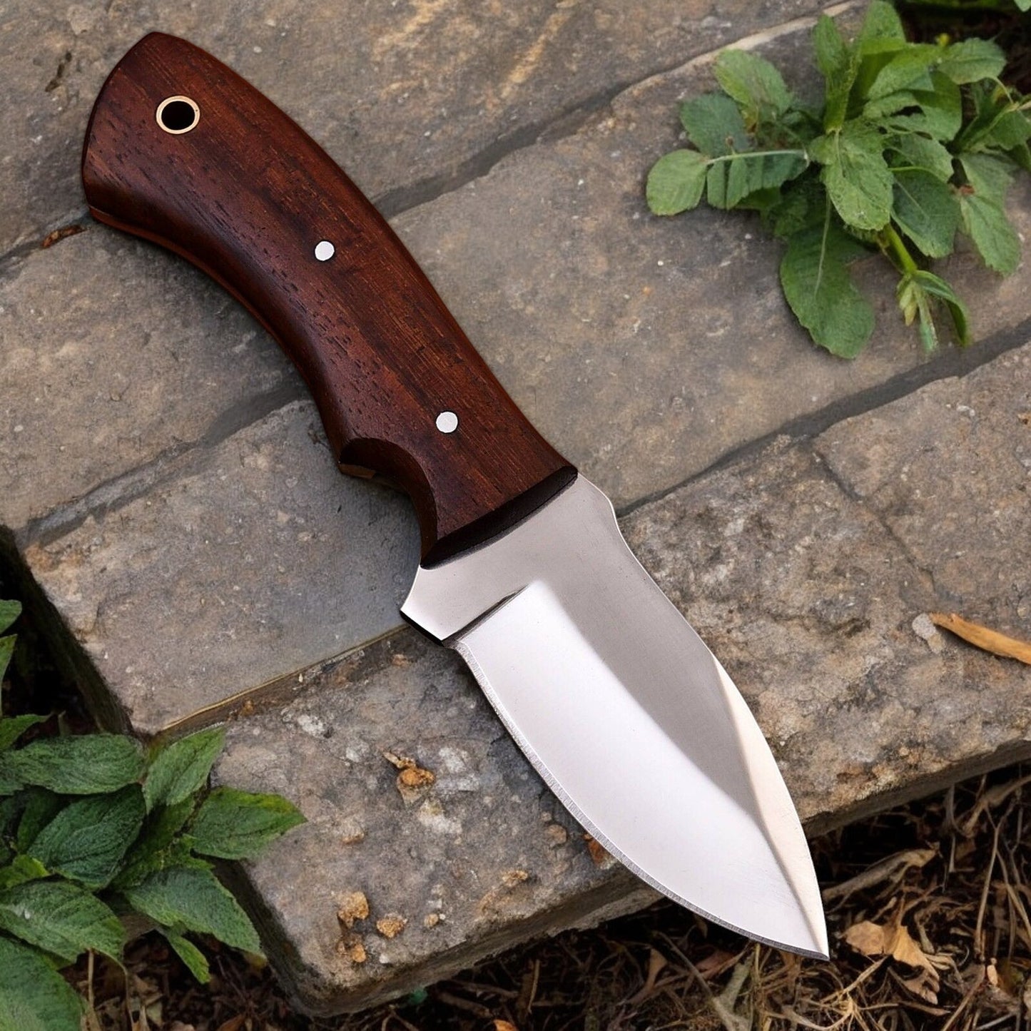 Close-up of high carbon steel blade on a handmade hunting knife, showcasing its sharpness.
