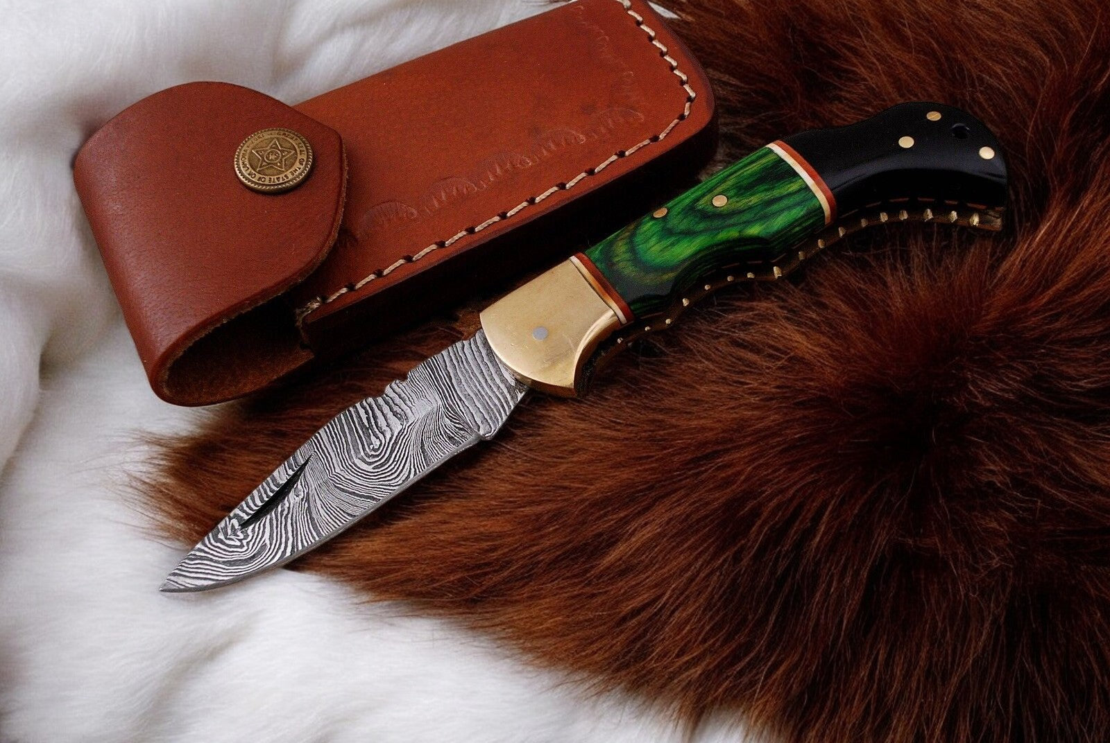Small folding knife with leather case for convenient carry

