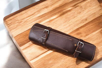 Premium leather roll showcasing neatly organized kitchen knives.
