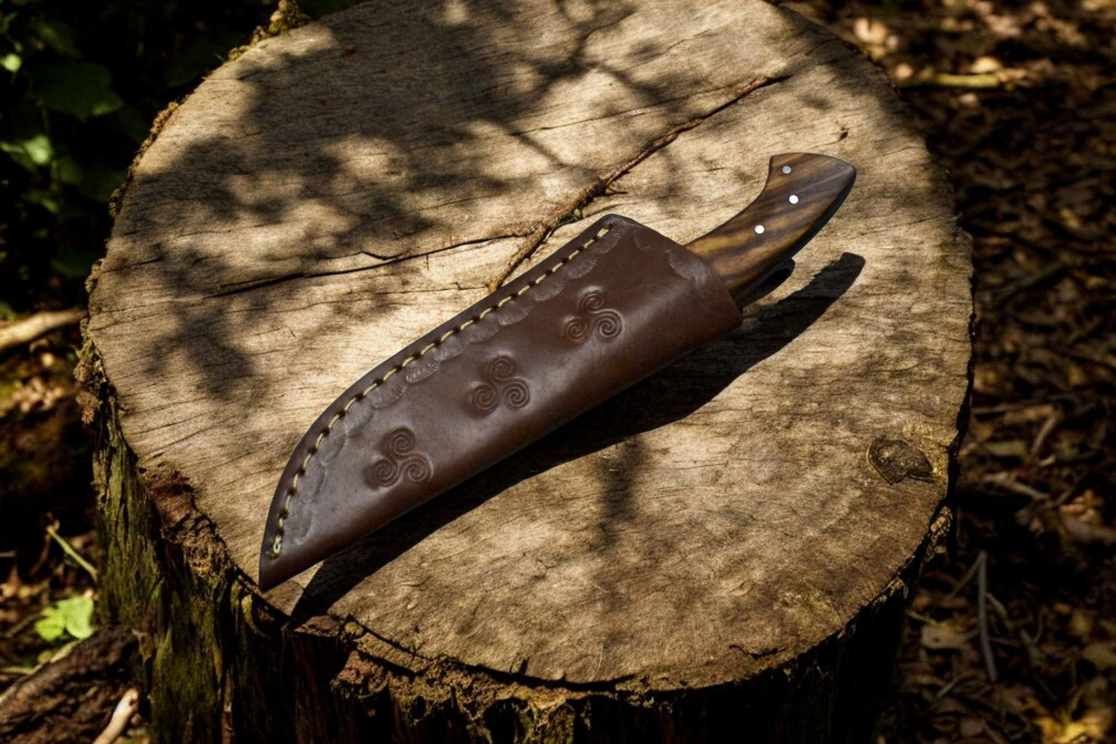 Complete view of a 9-inch custom skinning knife with a leather sheath.





