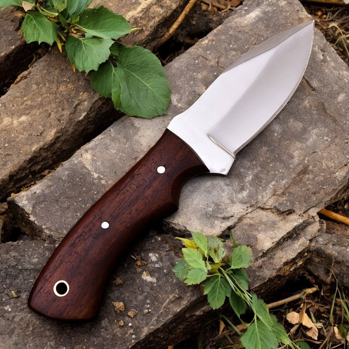 Handmade hunting knife in its leather sheath, ready for outdoor adventures.
