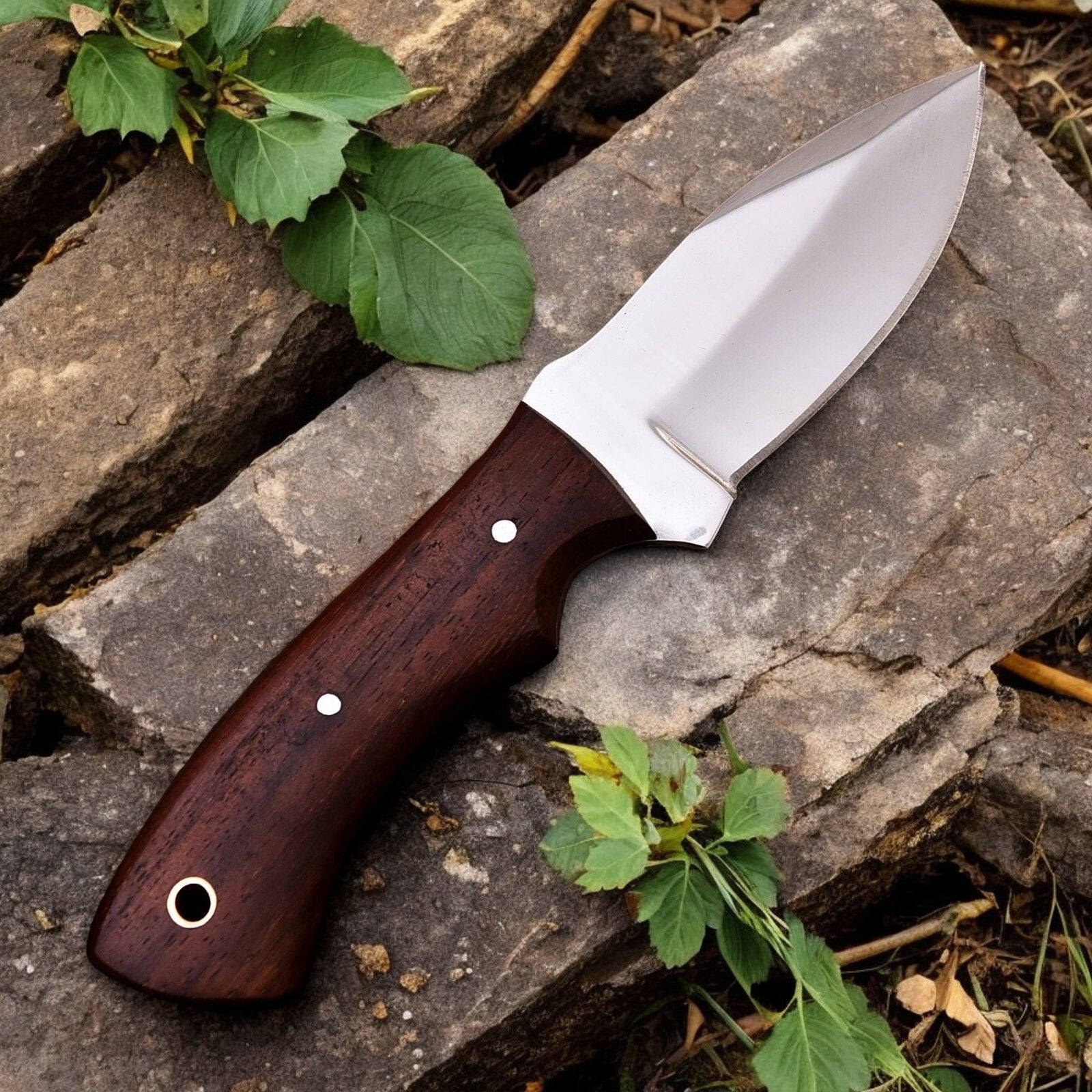 Handmade hunting knife in its leather sheath, ready for outdoor adventures.
