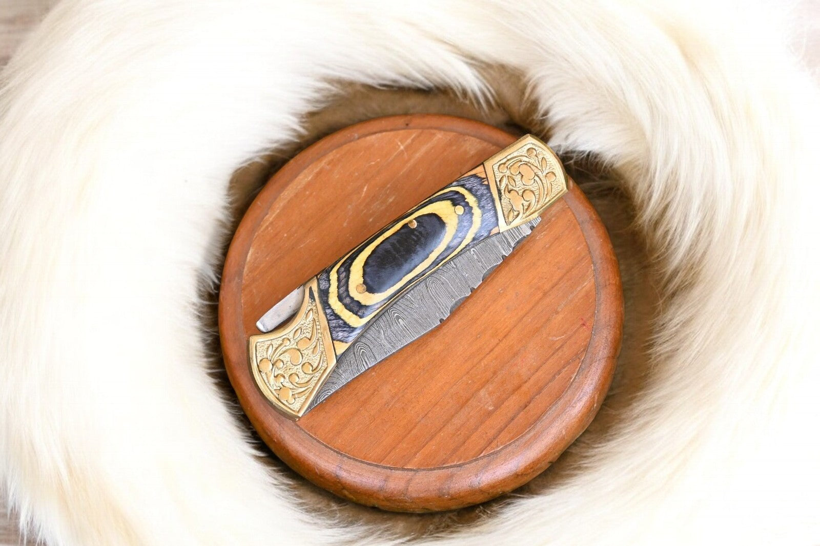 Detailed View of Engraved Brass Bolster on Folding Knife
