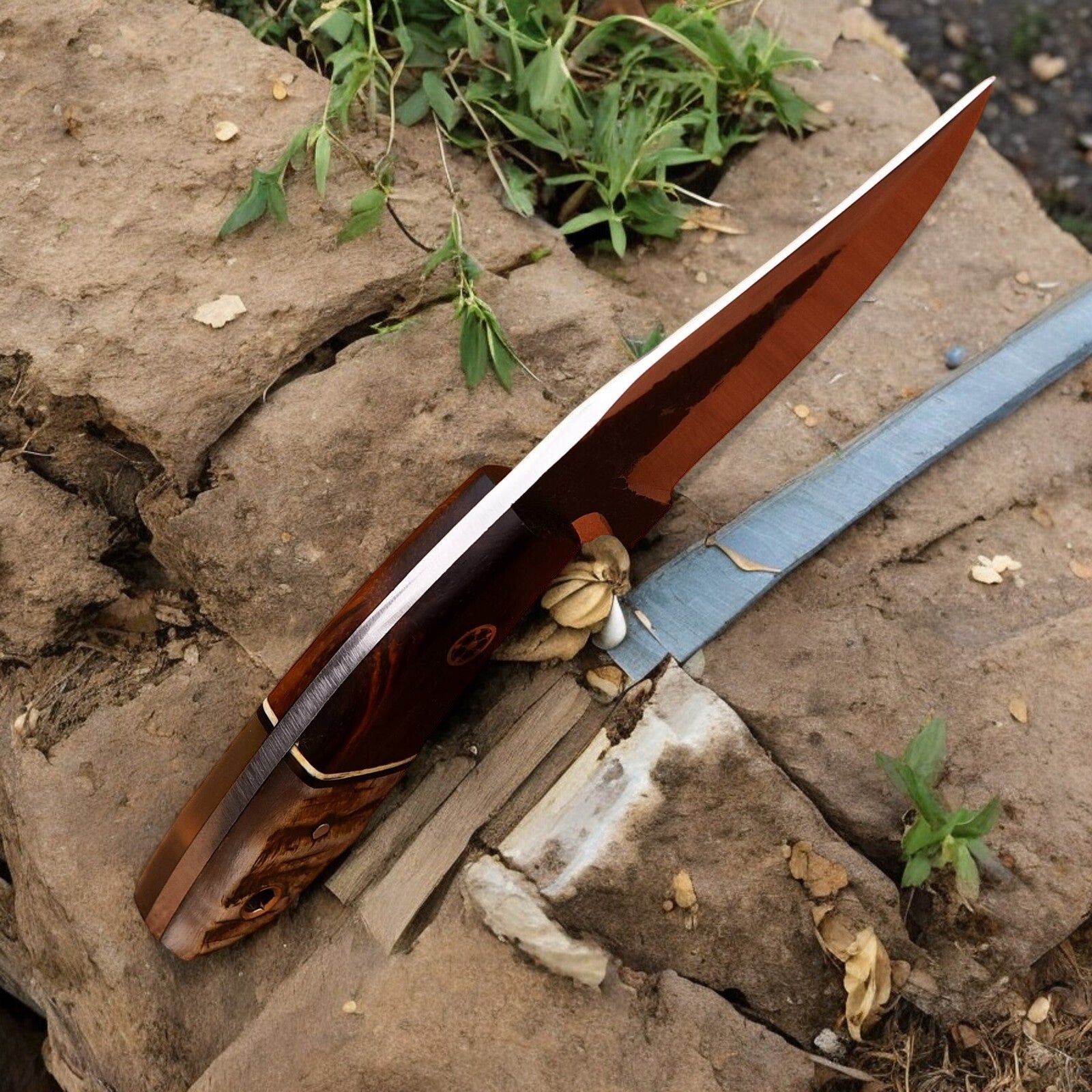 Close-up of high carbon steel blade on top hunting knife, highlighting sharpness.
