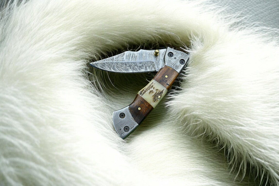 "Custom handmade Damascus pocket knife with rosewood and antler horn handle."
