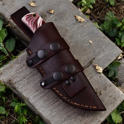 Leather sheath included with 7.5-inch steel hunting knife, displayed beside the knife.
